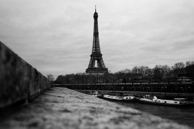 View of eiffel tower in city against cloudy sky
