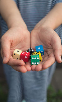 Midsection of girl holding dices