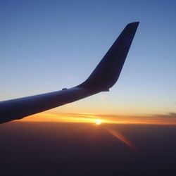 Cropped image of airplane flying over sky