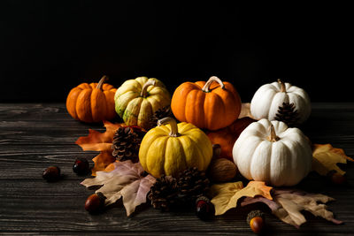 Close-up of pumpkins on table against black background