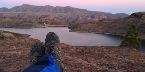 Low section of person relaxing in lake