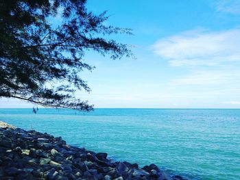 Scenic view of sea against blue sky