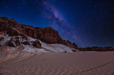 Scenic view of desert against sky at night