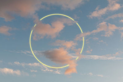 Low angle view of bubbles against rainbow in sky