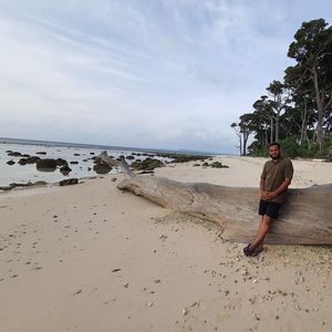 Full length of man on beach against sky