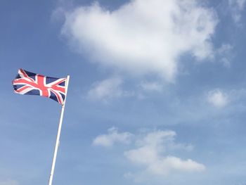 Low angle view of british flag against sky