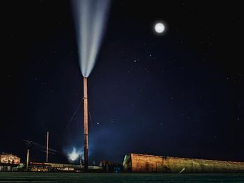 Low angle view of illuminated building against sky at night