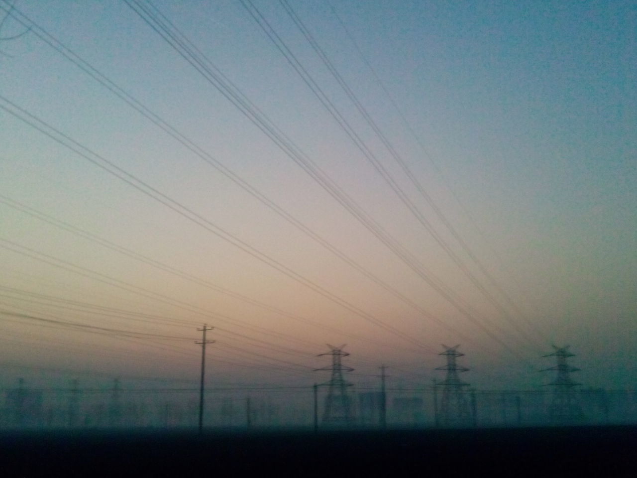 electricity pylon, power line, electricity, fuel and power generation, power supply, connection, technology, cable, sky, landscape, silhouette, sunset, tranquility, tranquil scene, dusk, nature, scenics, field, low angle view, beauty in nature