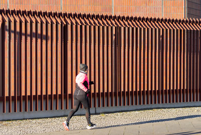 Full length side view of woman in city