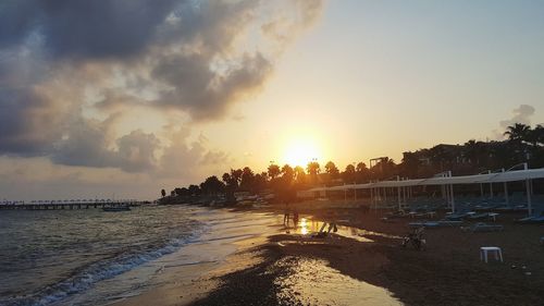 Scenic view of beach against sky during sunset