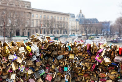 Padlocks on bridge railing in city