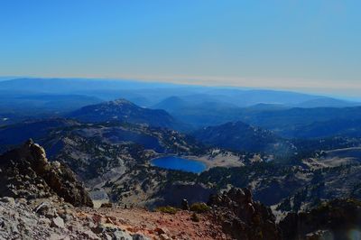 High angle view of mountains against blue sky