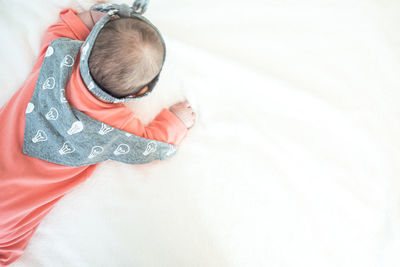 High angle view of cute baby lying on bed