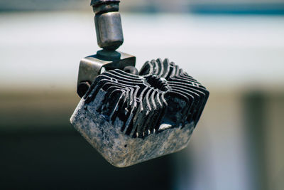 Close-up of padlock hanging on metal