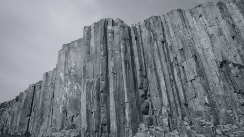 Low angle view of rock formation against sky