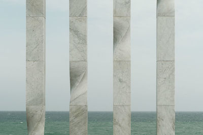 Close-up of built structure in sea against sky