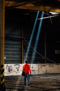 Full length of man standing by text on wall