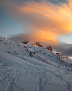 Scenic view of snowcapped mountains against sky during sunset