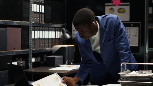 Side view of man working at table