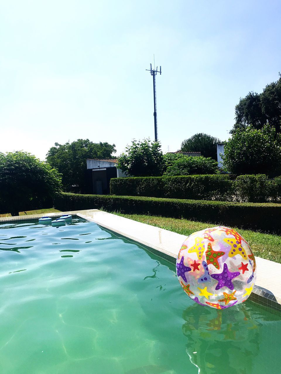 VIEW OF SWIMMING POOL AGAINST LAKE