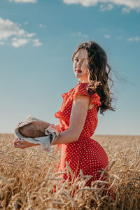 Midsection of woman on land against sky