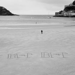 Scenic view of text on beach against sky
