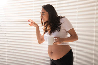 Beautiful woman standing by coffee