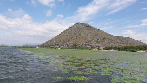 Scenic view of land and mountains against sky