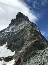 Low angle view of snowcapped mountain against sky