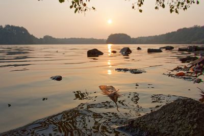 Scenic view of lake against sky during sunset