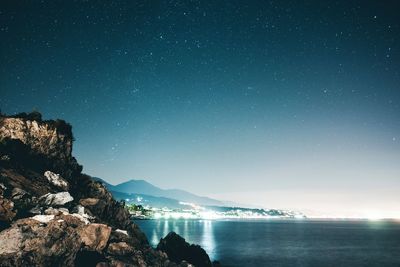 Scenic view of sea against sky at night