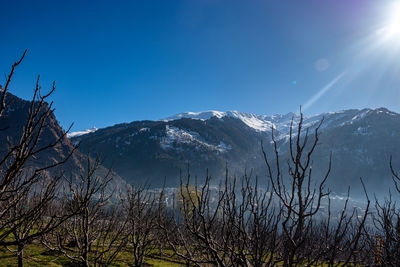 Scenic view of snowcapped mountains against clear blue sky