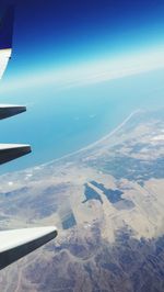 Cropped image of airplane flying over landscape