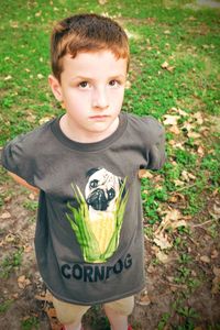 High angle view of cute boy standing on field