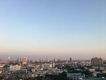 High angle view of buildings in city against evening sky