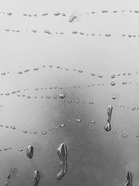 Full frame shot of raindrops on sand