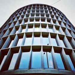 Low angle view of modern building against blue sky