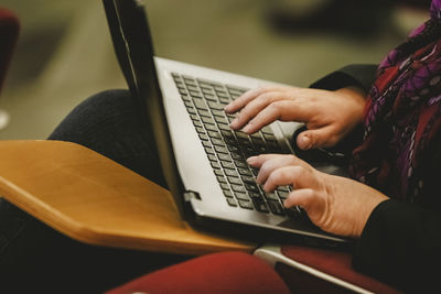 Midsection of woman using laptop