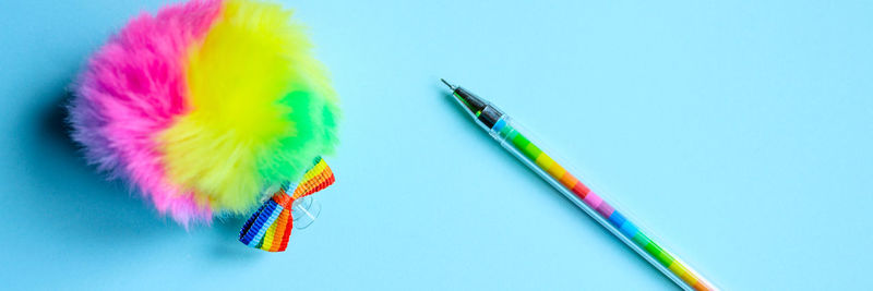 High angle view of colored pencils against blue background