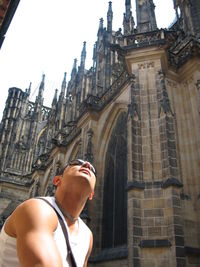 Low angle view of young man against building