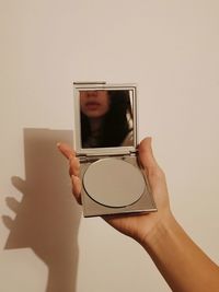 Cropped hand of girl holding glass