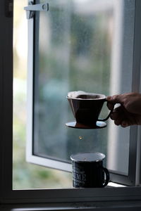 Hand holding coffee cup