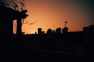 Silhouette of building against sky during sunset