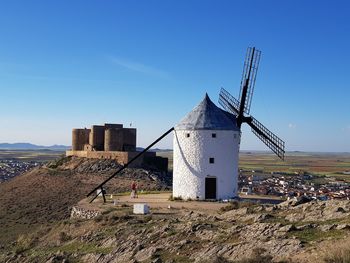 Traditional windmill on field against sky