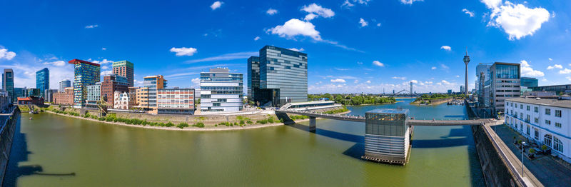 Panoramic view of river and buildings against sky