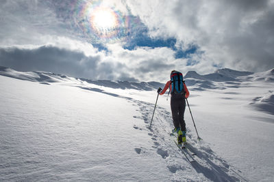 Full length of person on snowcapped mountain against sky