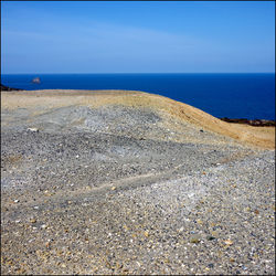 Scenic view of beach against blue sky