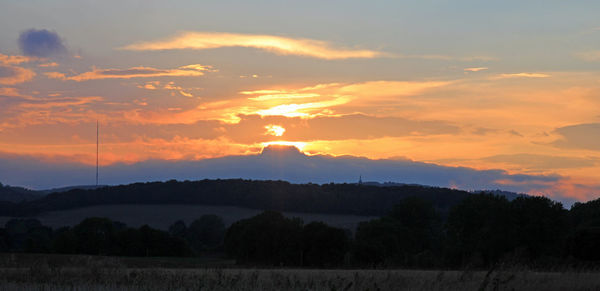 Scenic view of silhouette landscape against sky during sunset