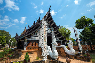 Low angle view of temple against cloudy sky