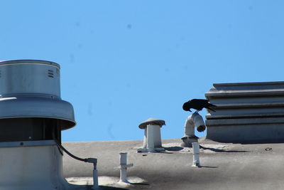 Close-up of built structure against blue sky